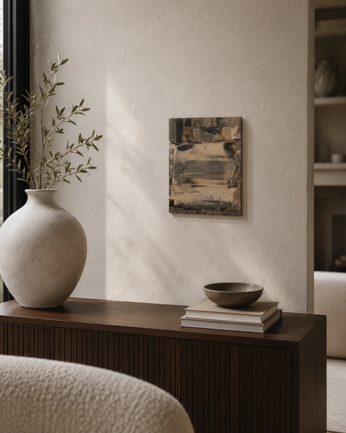 Ash Grain, a small brown, cream, and black horizontal-banded abstract painting by Julia Mindar, leaning against a wall