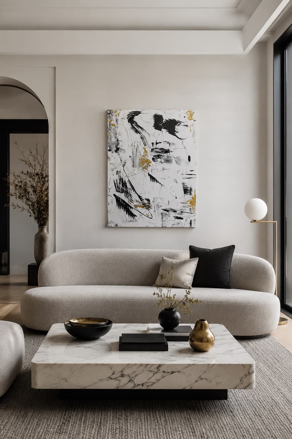 Golden Plume, a black, white, and gold leaf abstract painting by Julia Mindar, shown installed above a sofa in a living room