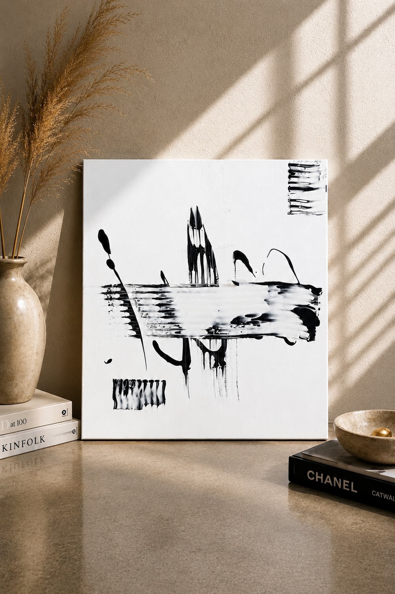 Still Horizon, a black and white square abstract painting by Julia Mindar, styled with design books on a console