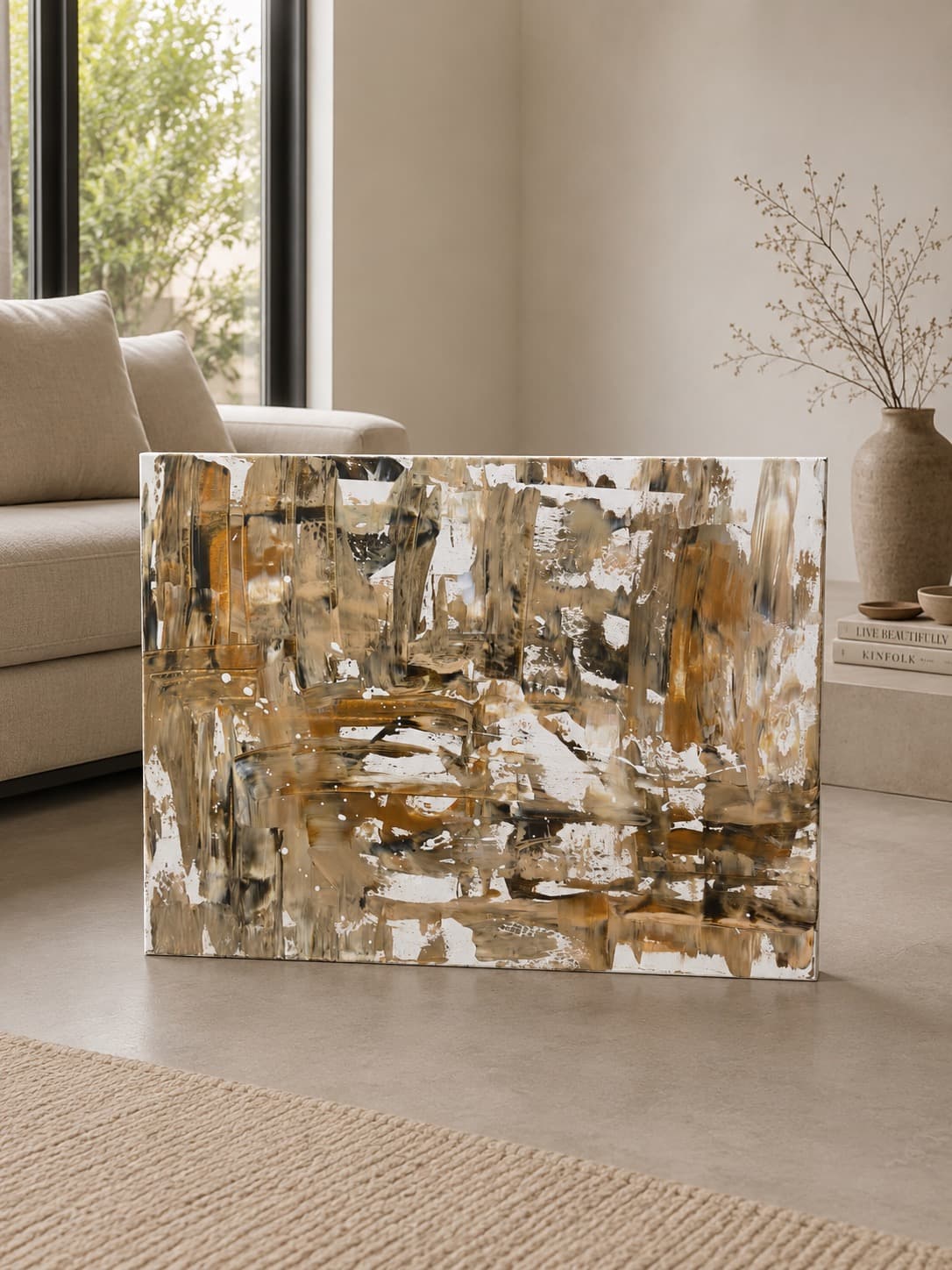 Urban Relic, a warm beige, taupe, and burnt umber textured abstract painting by Julia Mindar, leaning against a wall